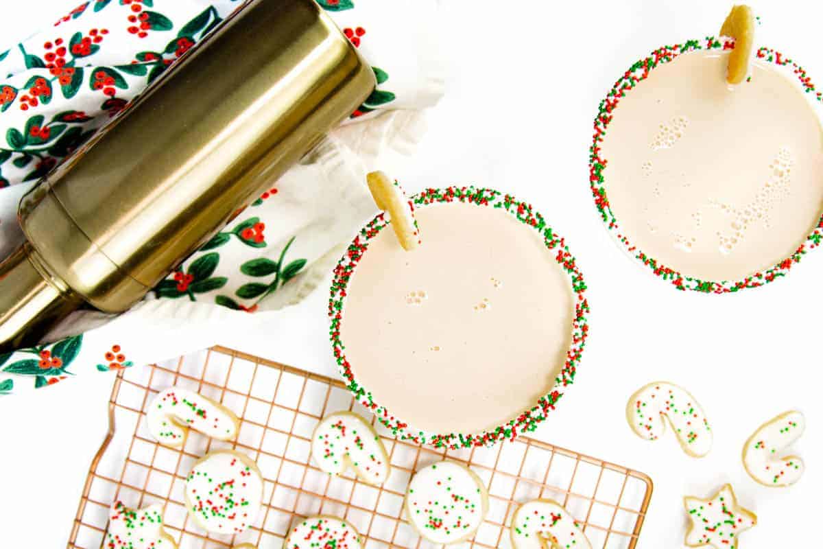 Two sugar cookie martinis with red and green sprinkle rims.