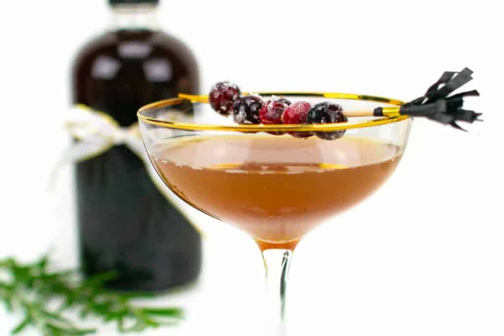 A sugar plum sidecar with a bottle of plum brandy.