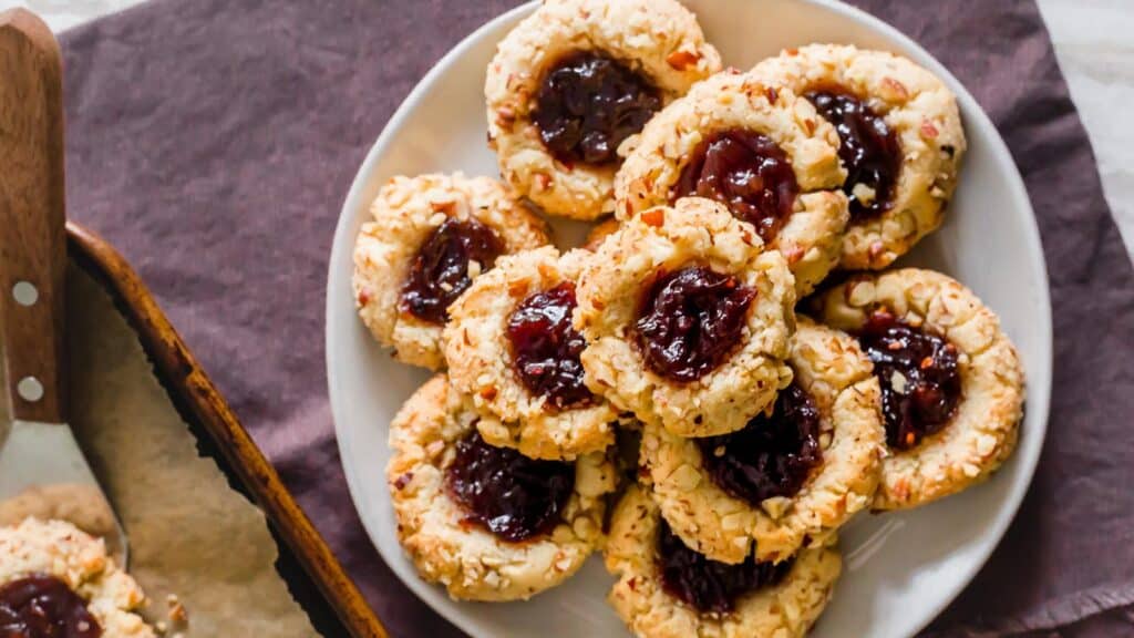 Jam filled thumbprint cookies on a plate.