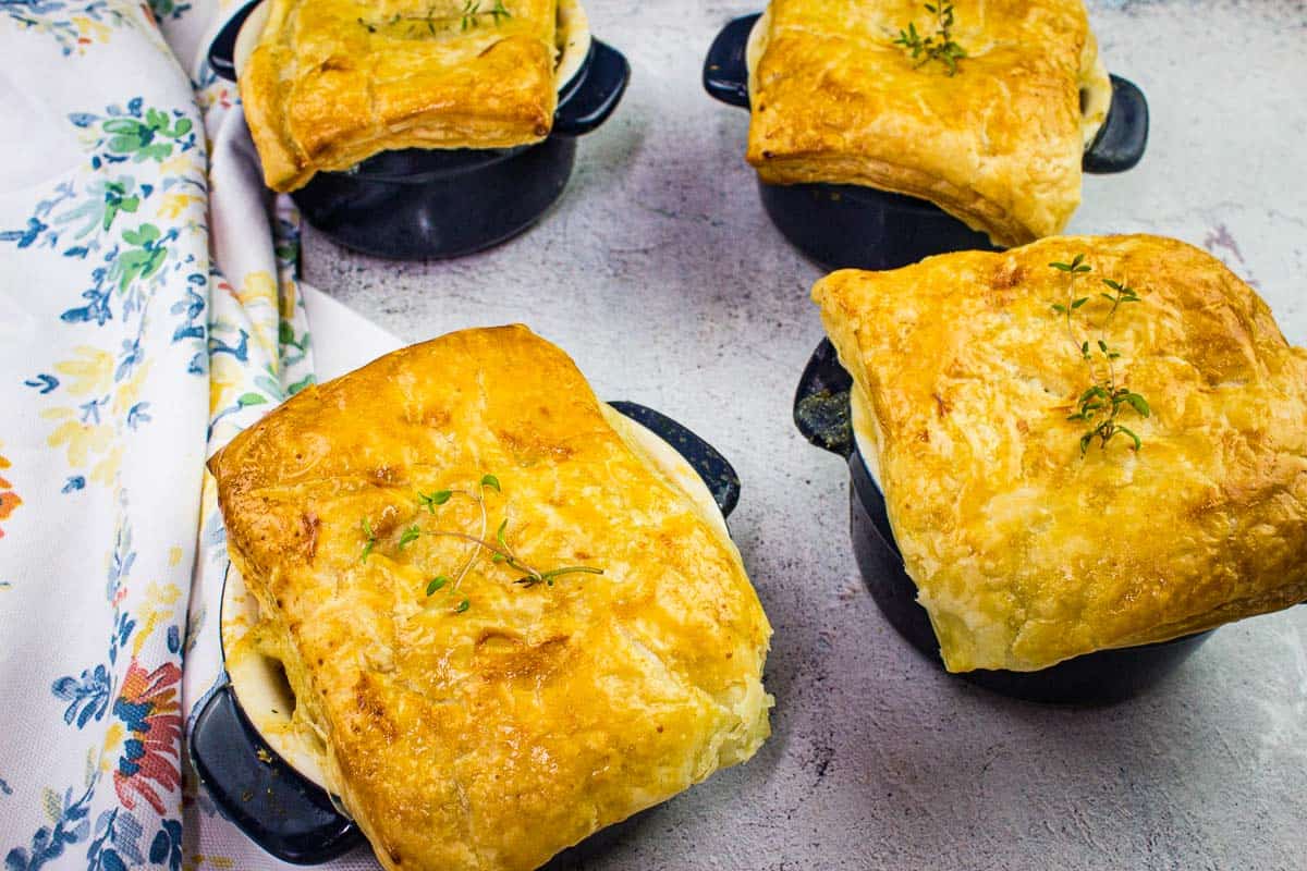 Turkey Pot Pies with Puff Pastry on a counter.