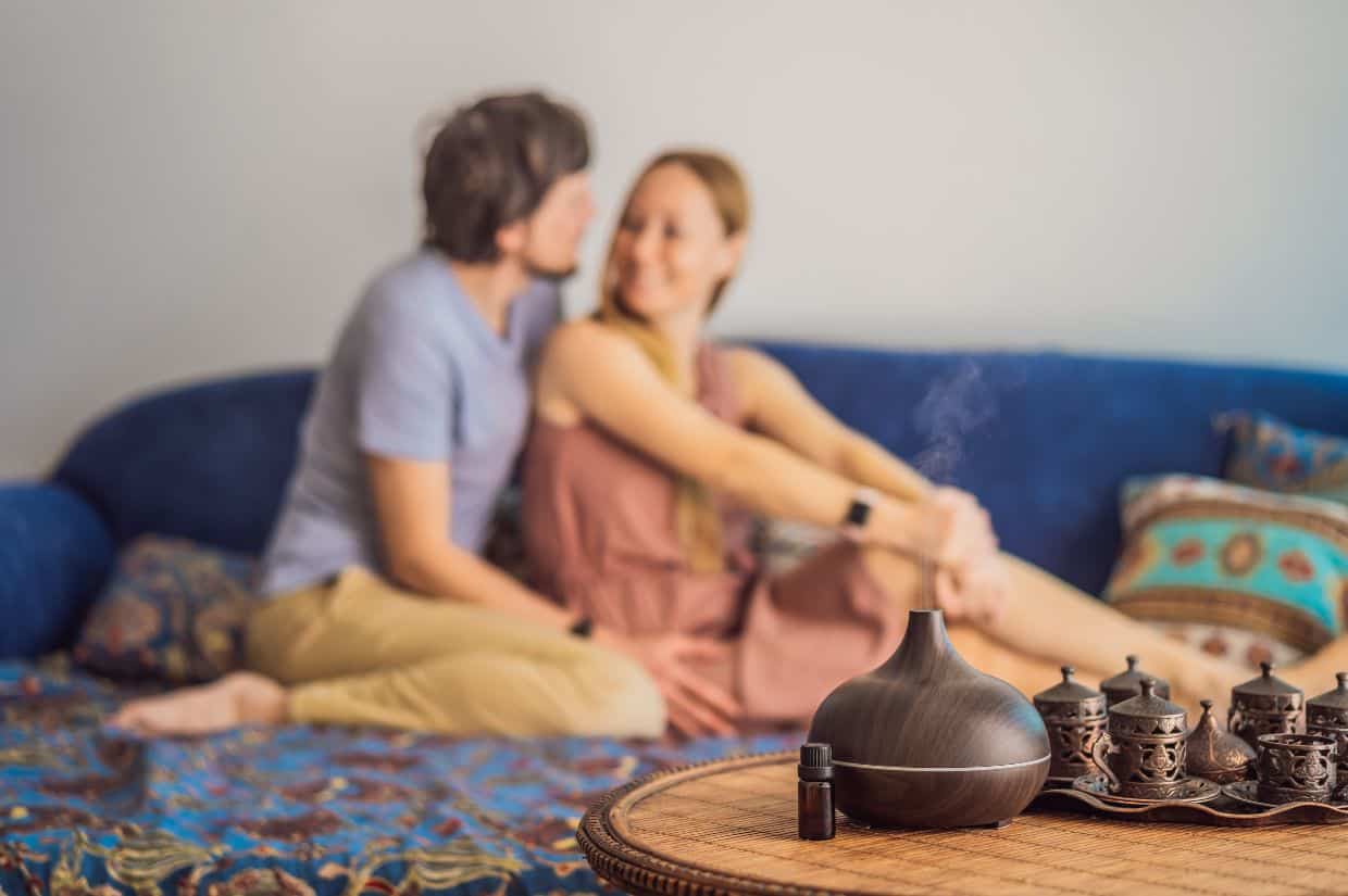 A picutre of a couple resting at home with an ultrasonic Essential Oil Aroma Diffuser and Humidifier.