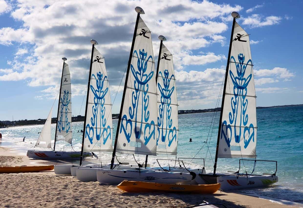 Image shows  Beaches resorts sailboats on the beach.