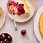 A slice of cherry cheesecake on a plate.