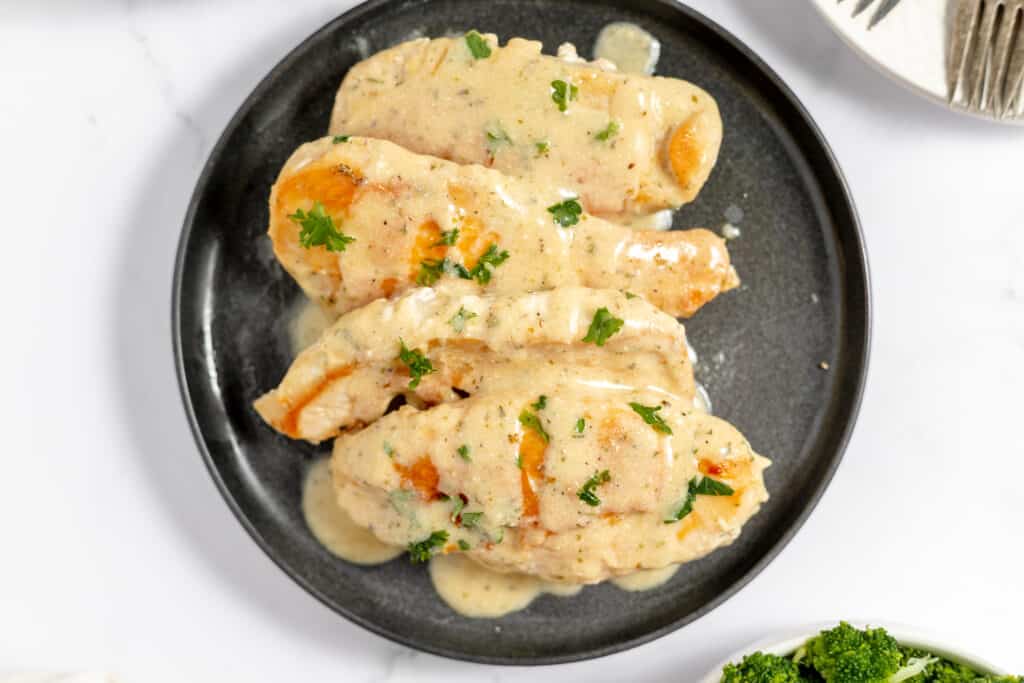 Chicken breasts with a ranch sauce on a plate.