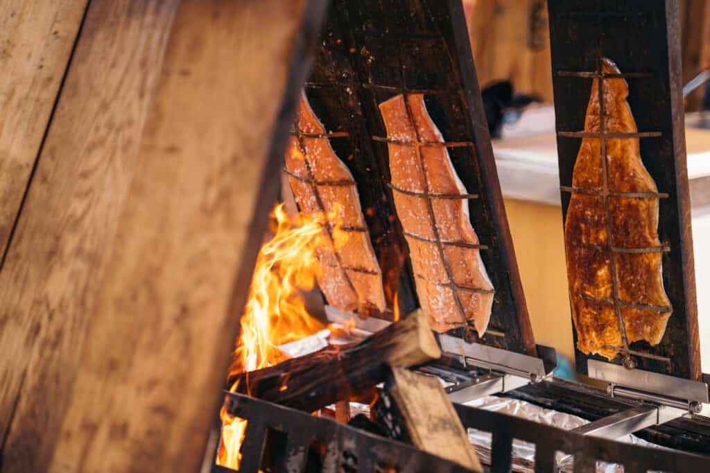 A German Christmas market featuring a grill with a fire on it.