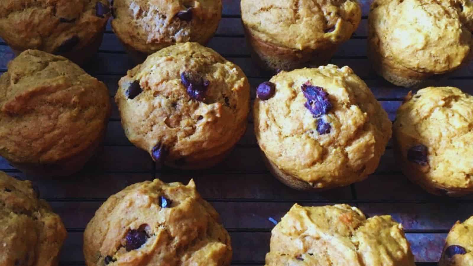 Pumpkin chocolate chip muffins on a cooling rack.