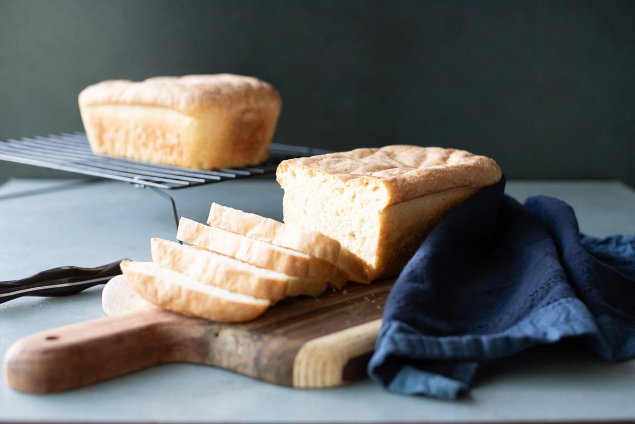 A loaf of bread is sitting on a cutting board.