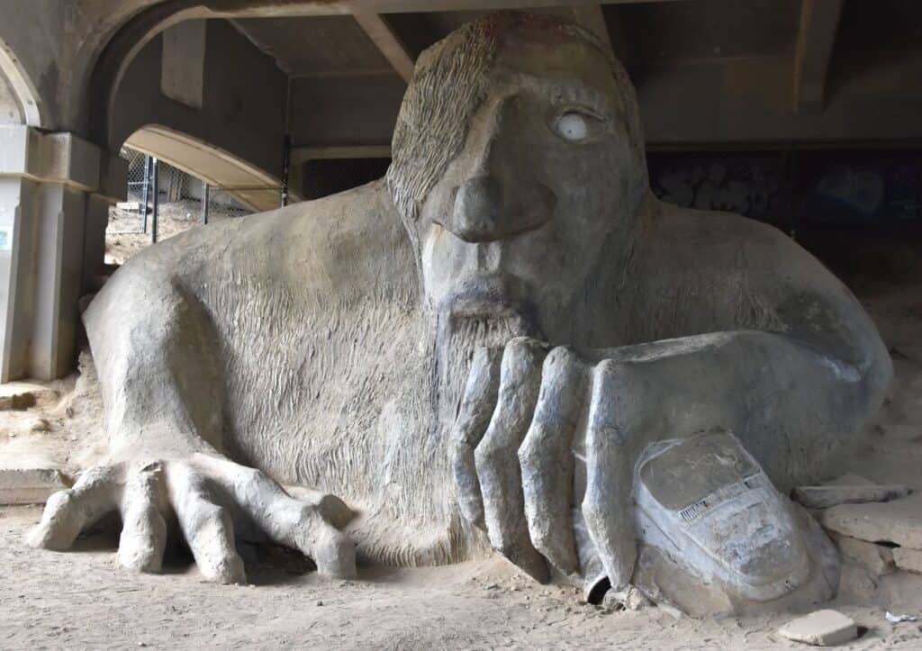 A colossal bridge sculpture featuring a monstrous creature, a must-see in Seattle.