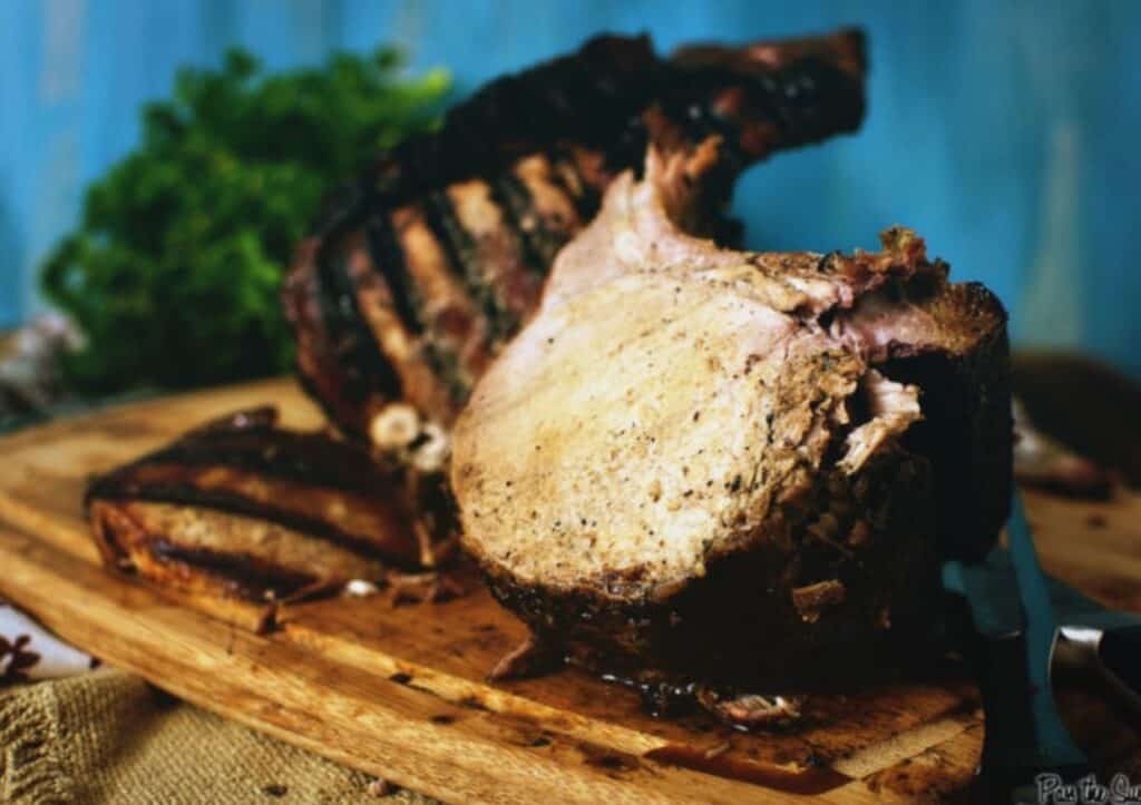 A pork roast on a wooden cutting board.