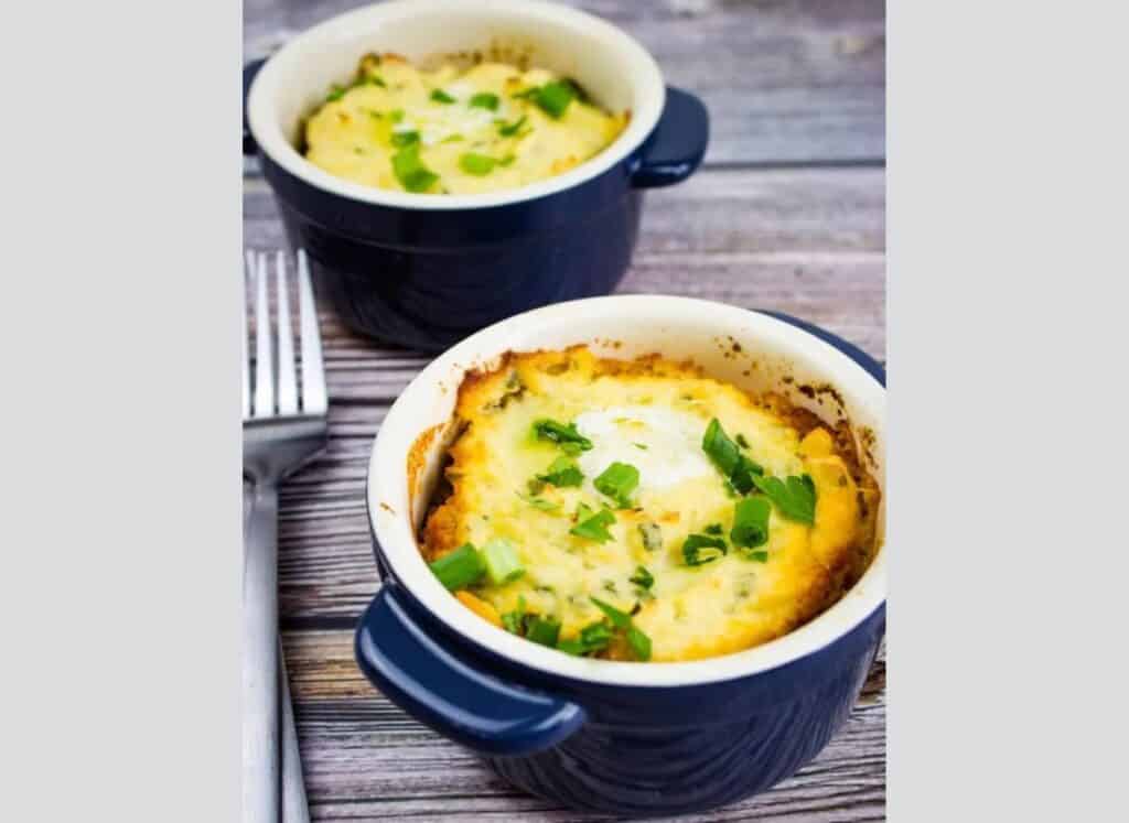 Two bowls of Meatloaf Casserole with a fork on a wooden table.