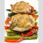 Garlic Chicken Skillet with peppers and asparagus on a white plate.