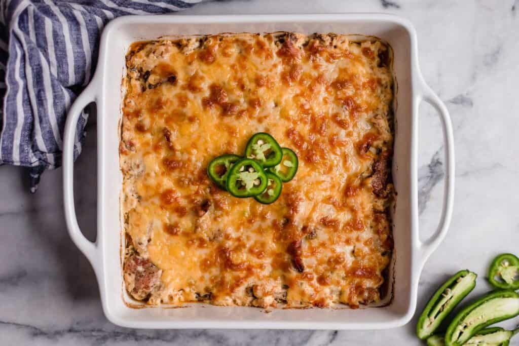 A chicken casserole dish with cheese and jalapenos.