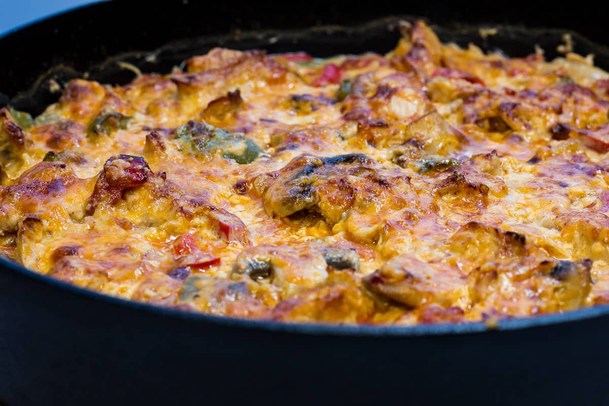 A skillet full of chicken and vegetables in a pan.