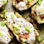 Zucchini boats stuffed with bacon and sour cream.