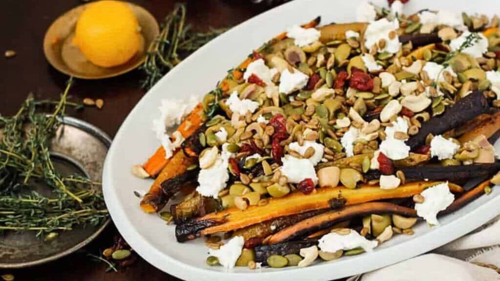 Middle Eastern roasted carrots with olives, goat cheese, salad topper and harissa-preserved lemon dressing