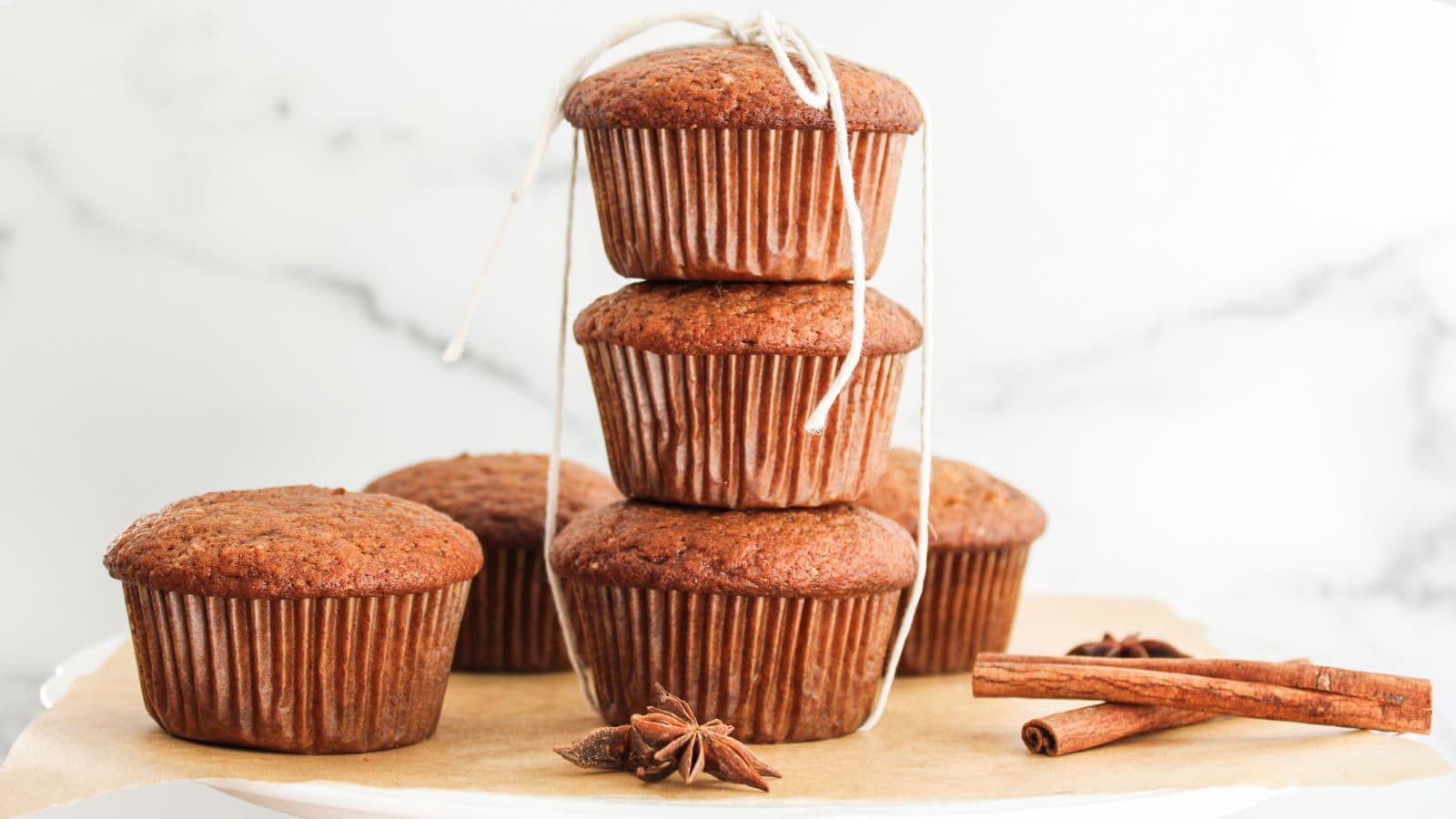 A stack of pumpkin spiced muffins on a plate.