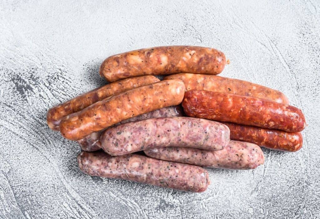 Image shows A pile of chorizo sausages on a gray surface.
