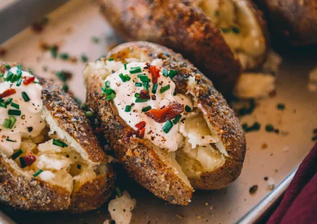 Baked potatoes topped with sour cream and chives.