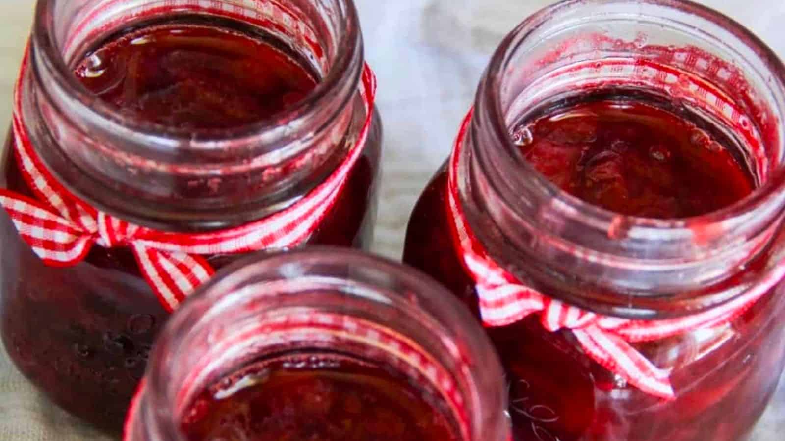 Strawberry syrup in mason jars.