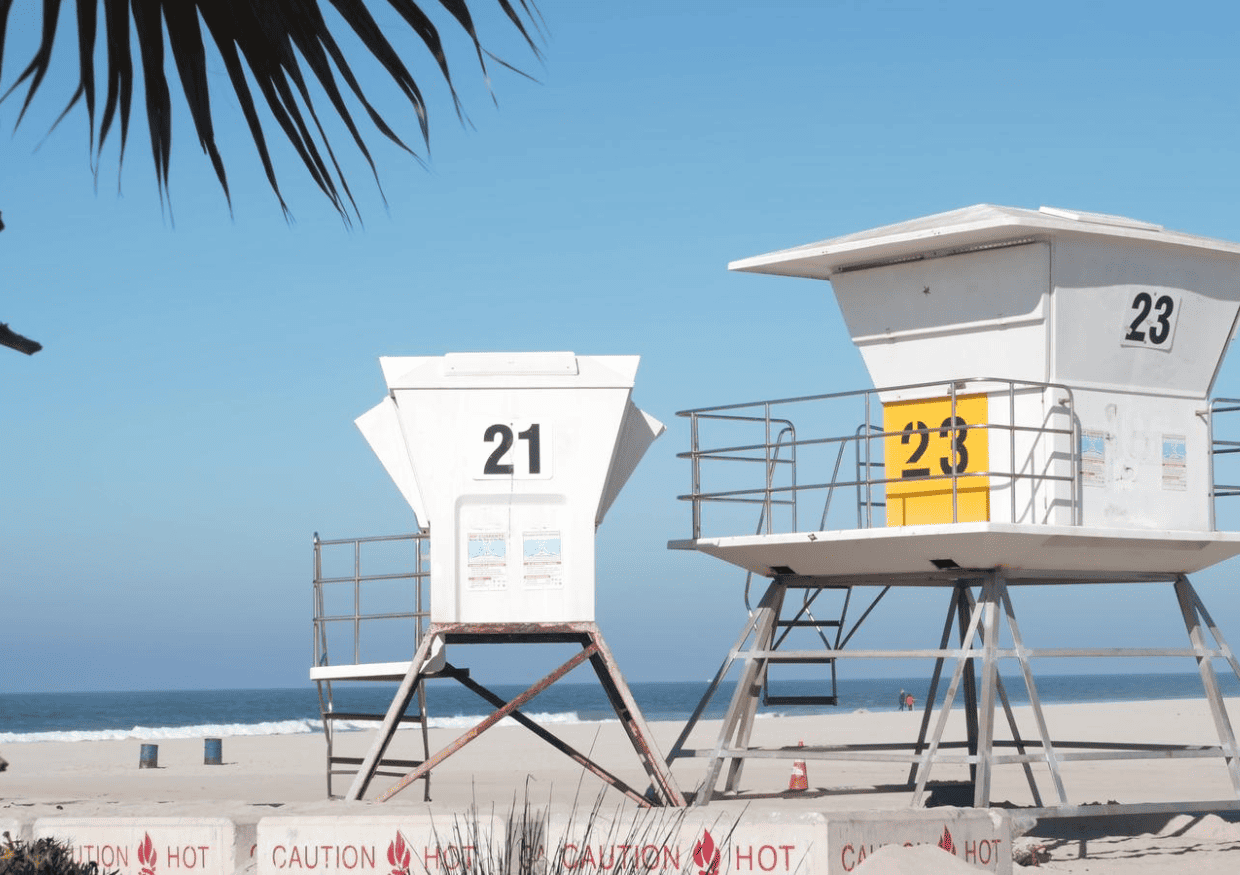 Two lifeguard towers on the beach.