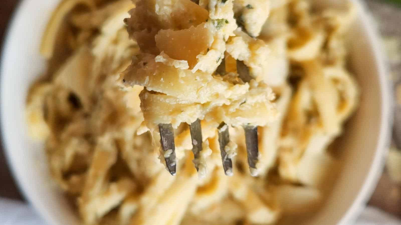 Zucchini parmesan pasta on fork.