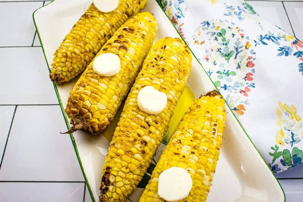 Air Fryer Corn on the Cob with slices of butter on top.