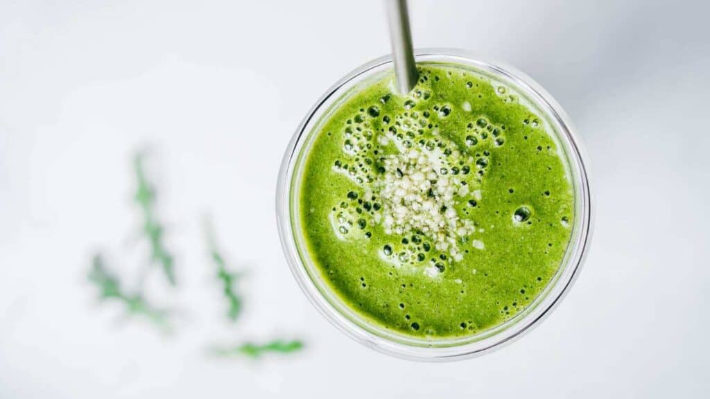 Green smoothie with a spoon.