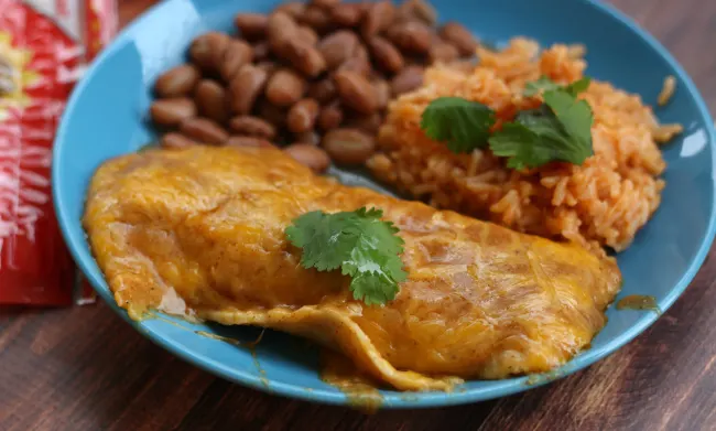One cheese enchilada and rice and beans on a plate.