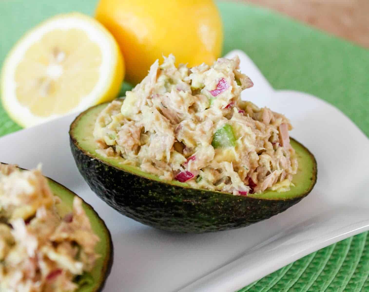 An avocado shell stuffed with avocado tuna salad.