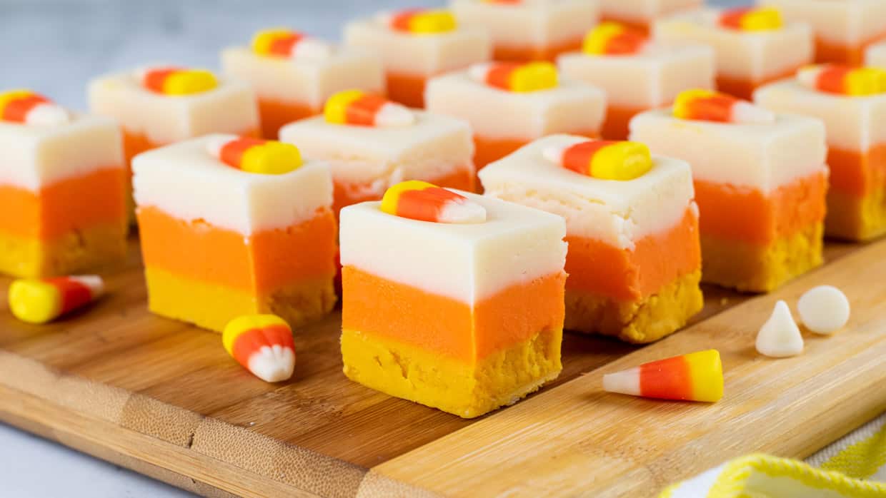 Candy corn fudge squares on a cutting board.
