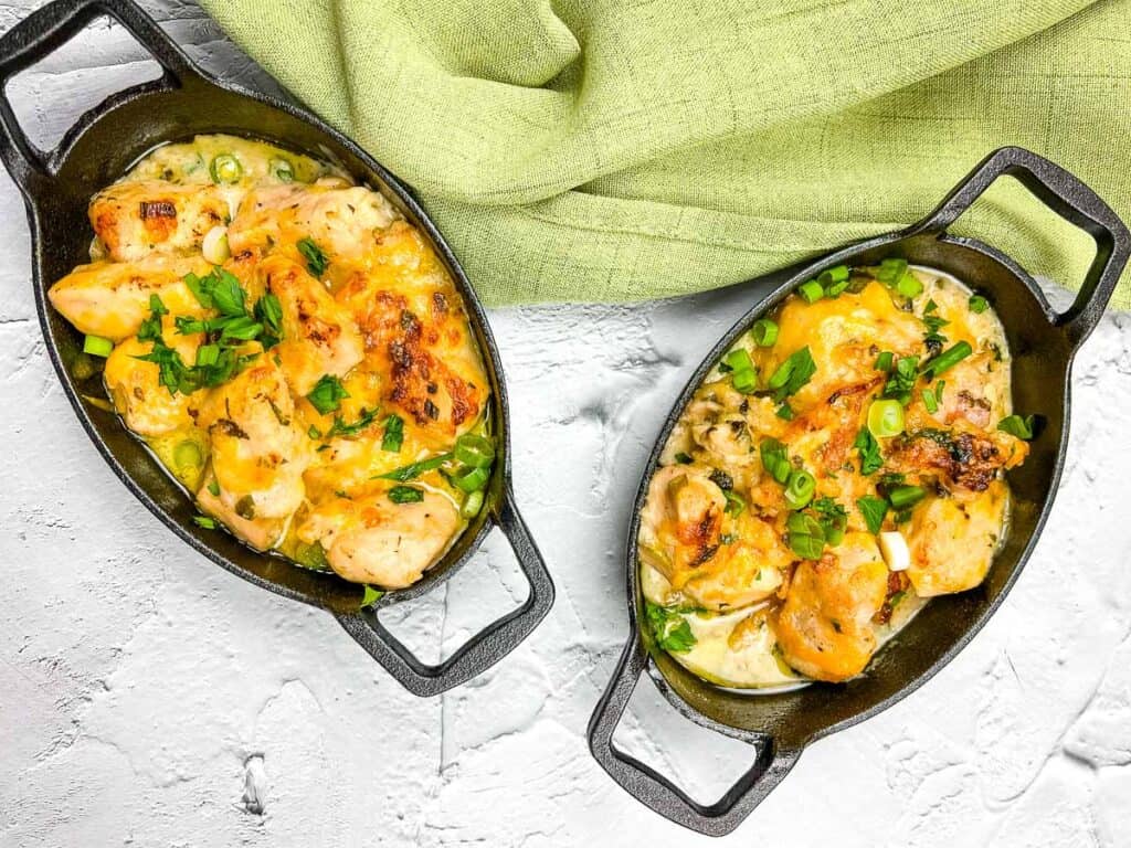 Two skillets filled with Chicken Bacon Ranch Casserole on a white background.