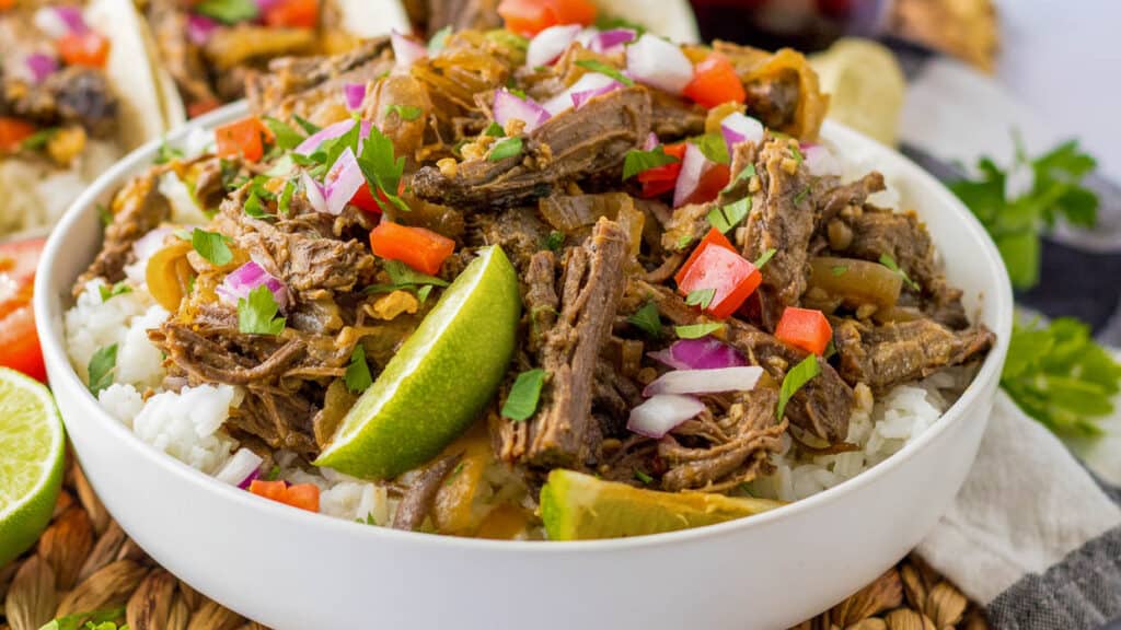 Mexican barbacoa in a bowl with rice.