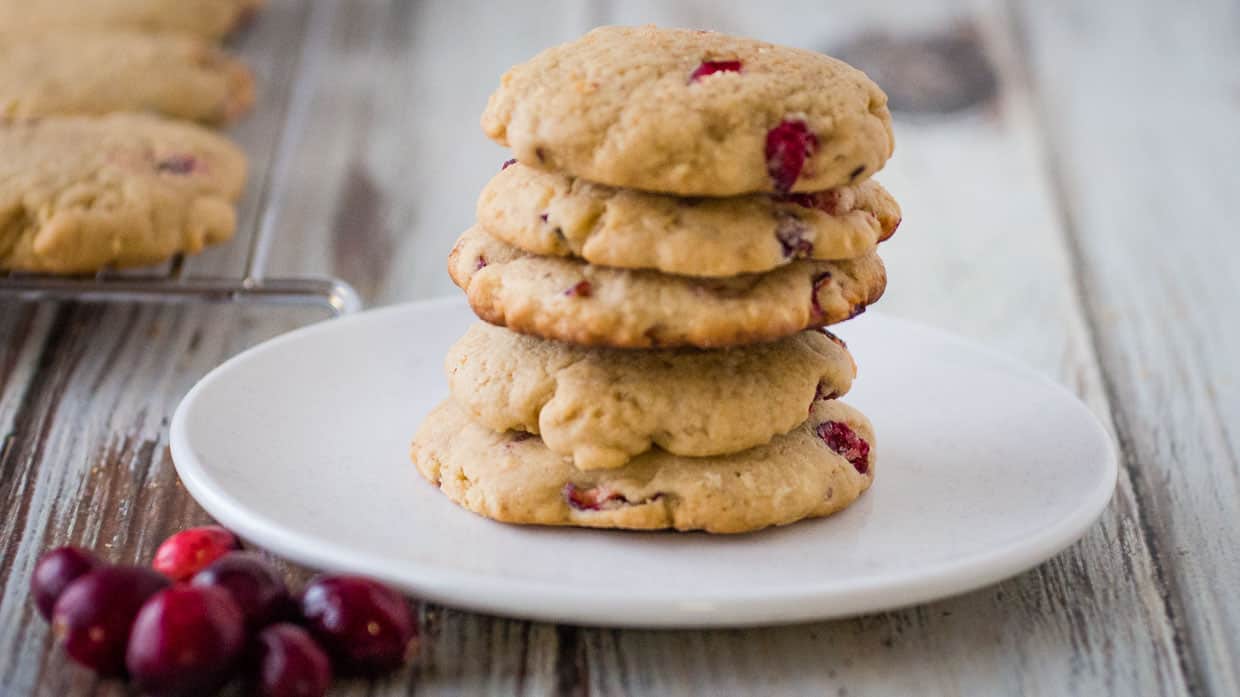A stack of cranberry cookies on a plate.
