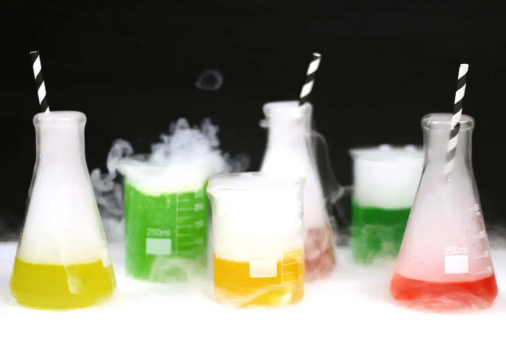 A group of beakers filled with different colored liquids.
