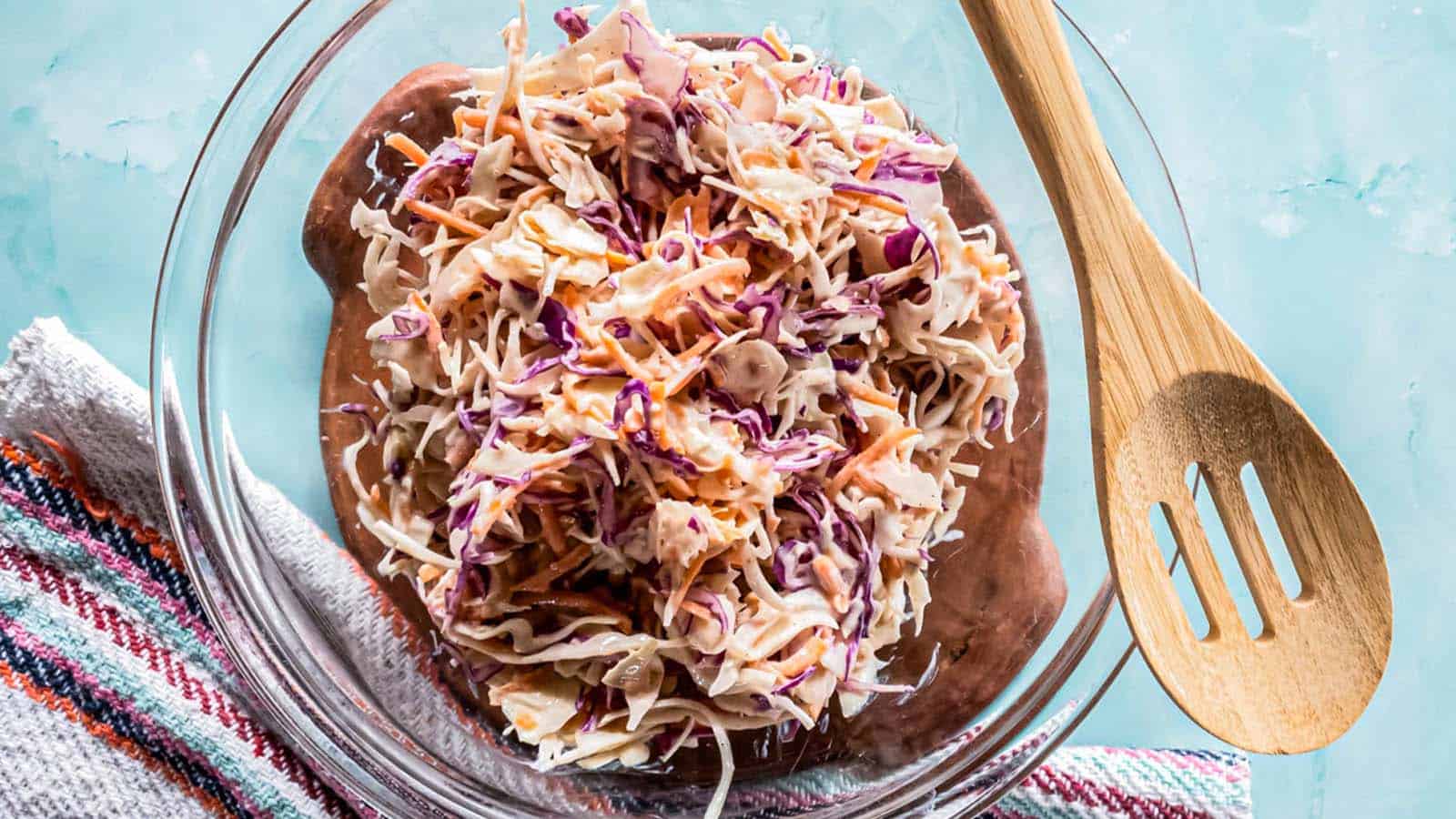 A picture of low-carb coleslaw recipe with creamy dressing in glass bowl.