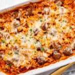 A casserole dish with meatballs and pasta.