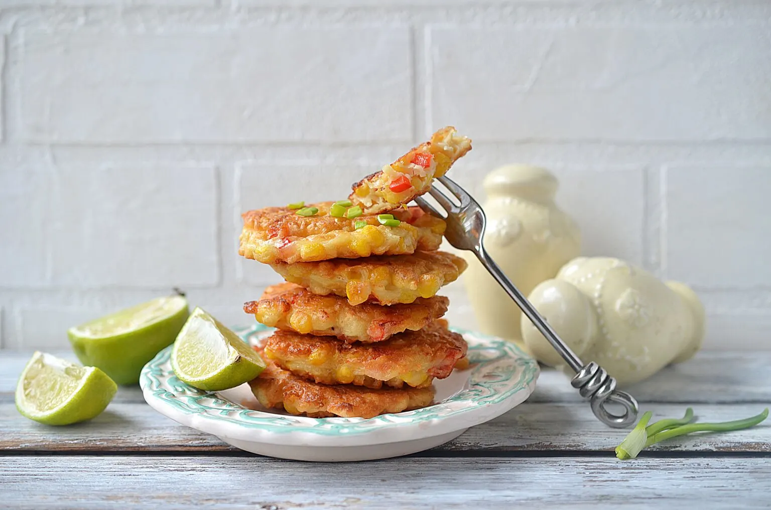 Stack of Mexican corn cakes on a white plate with a fork.