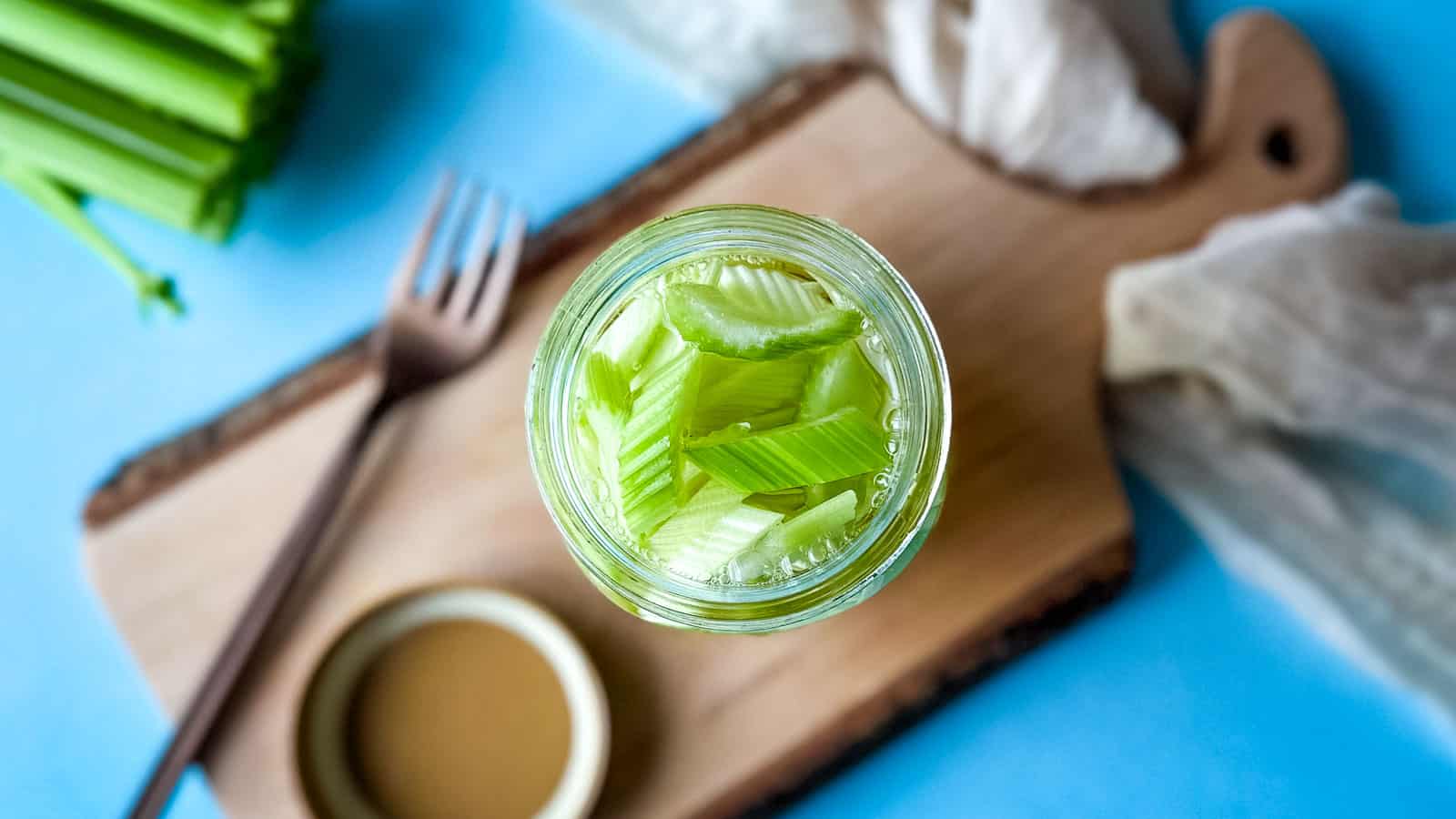 Pickled celery in a glass jar.