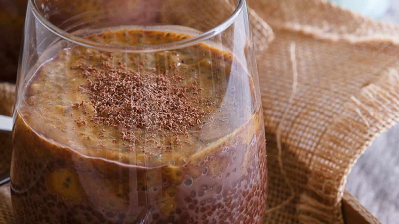 Chocolate pumpkin chia pudding in a glass dusted with cacao shavings.