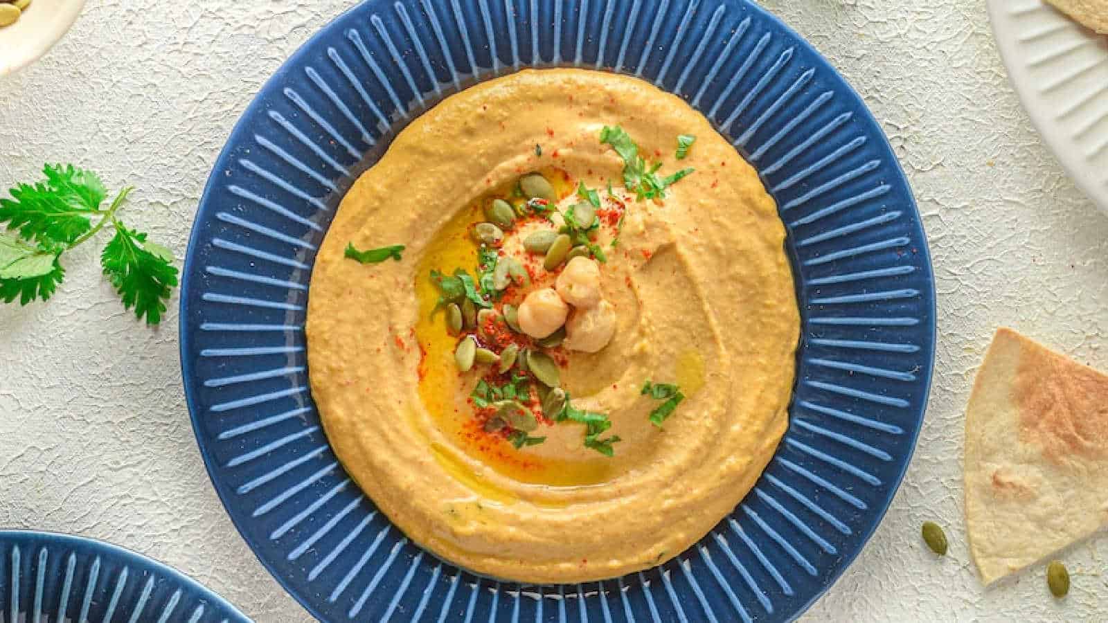 Close-up view of Vegan Pumpkin Pie Hummus, highlighting its smooth texture and vibrant color, perfect for a creative and seasonal snack.