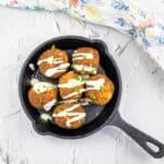 Sauerkraut Balls in a skillet on a white background.