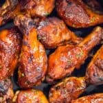 Slow cooker bbq chicken legs in the crock pot after cooking.