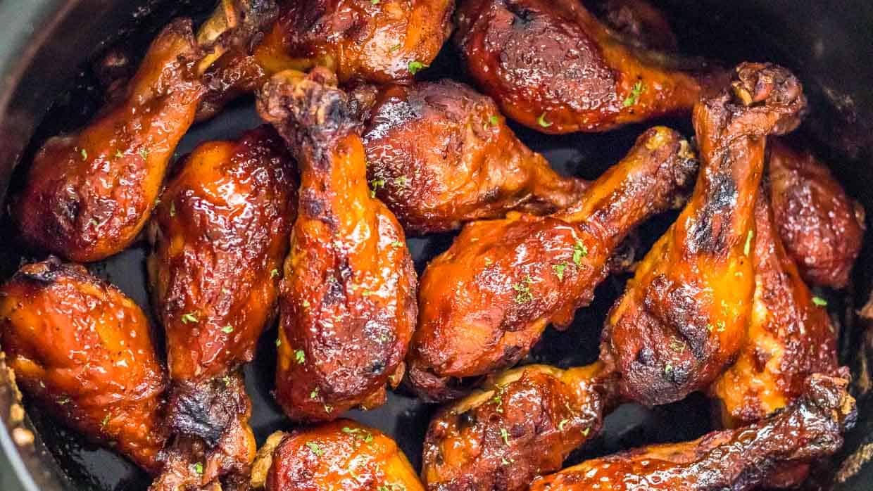 Slow cooker bbq chicken legs in the crock pot after cooking.
