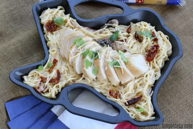 Texas shaped cast iron skillet with pasta and chicken.