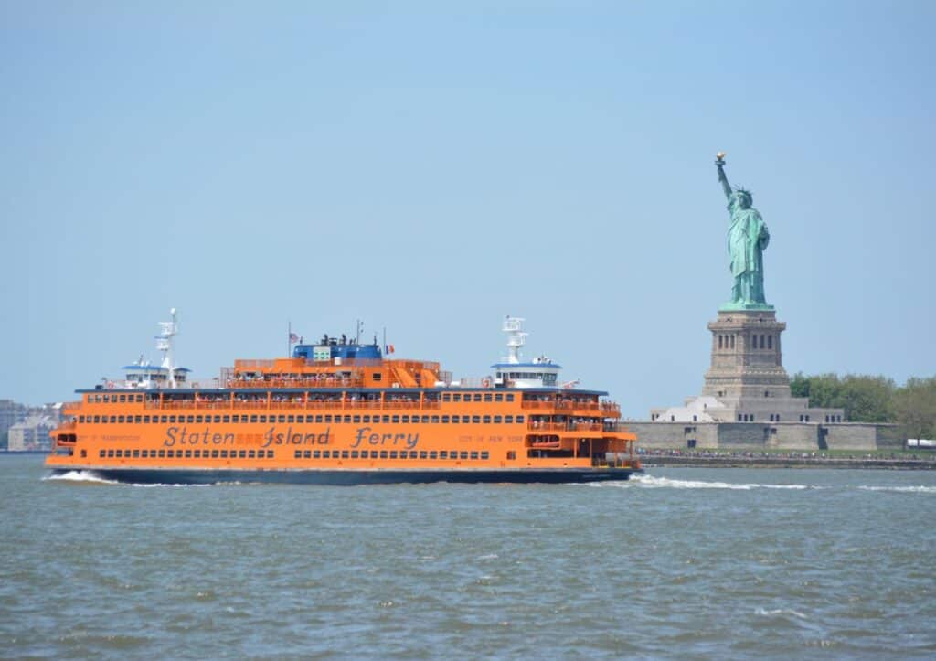 View of the Staten Island Ferry and Statue of Liberty in New York Harbor.