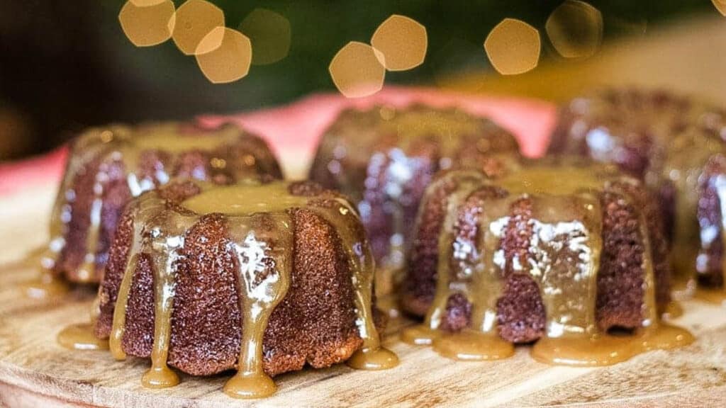 A plate of sticky toffee pudding cakes with caramel sauce.