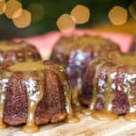 A plate of sticky toffee pudding cakes with caramel sauce.