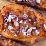 Sweet potatoes with pecans and nuts on a cutting board.