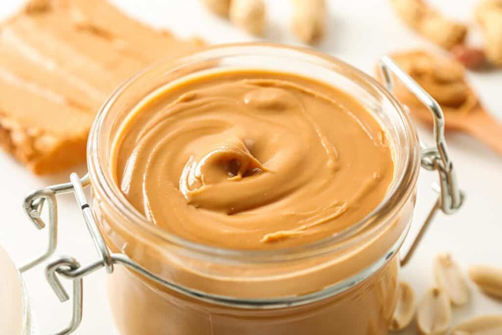 Peanut butter in a jar on a white background.