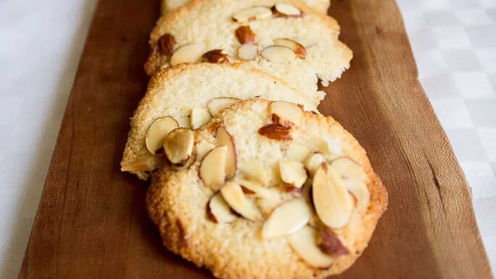 Almond cookies on a wooden cutting board.